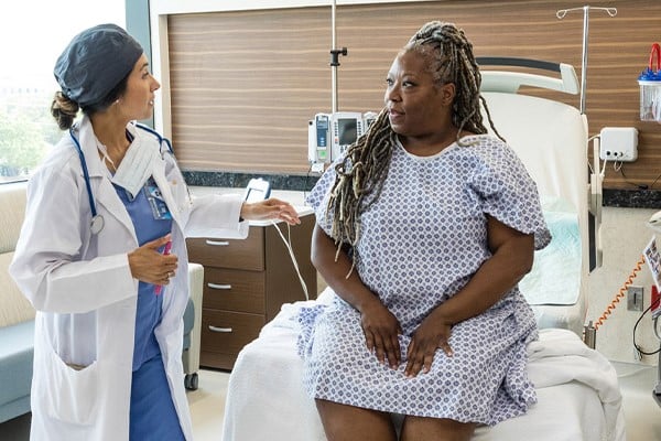 provider and patient talking in hospital room