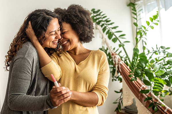 Two women celebrating pregnancy test