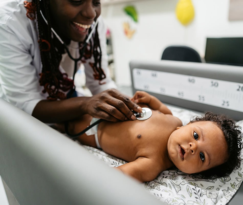 Pediatrician listening to baby's heart