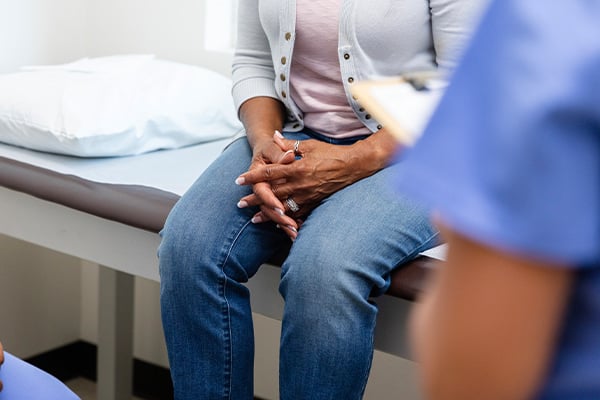 Woman sitting on exam table