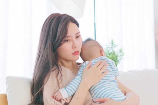 mom holding baby
