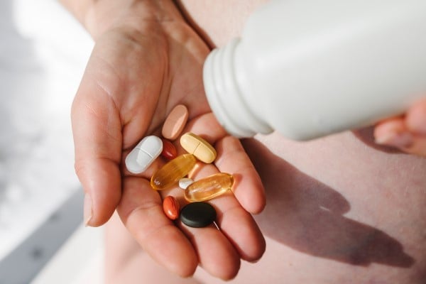 hand with bottle of pills