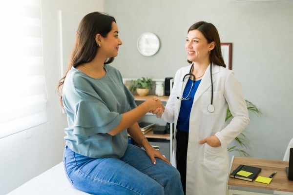 woman and doctor shaking hands