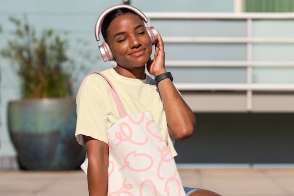 Young woman listening to music in the sunshine
