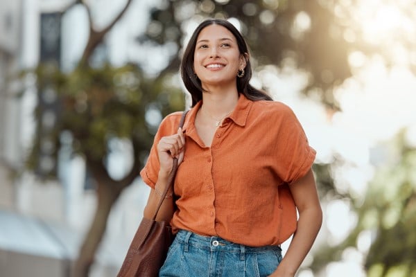 A woman walking outside and enjoying the sun