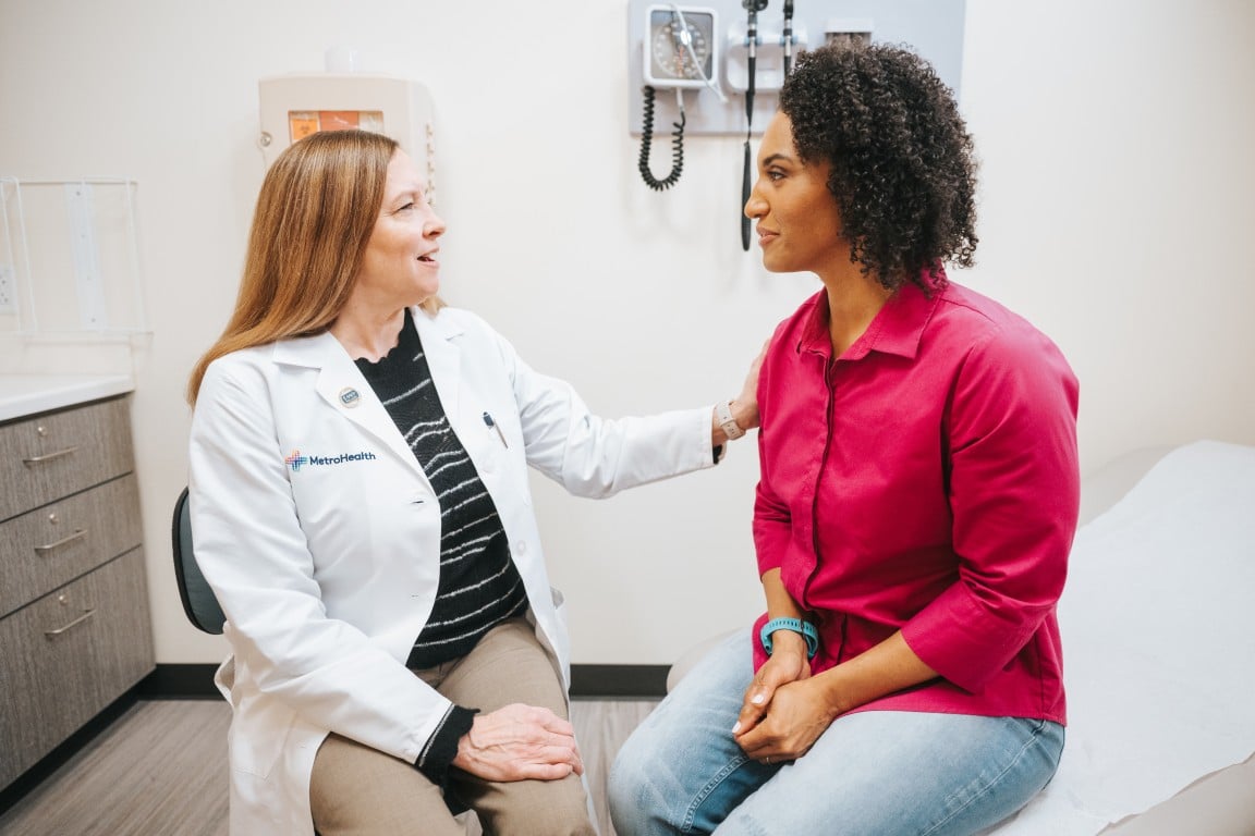 A patient and her provider in an exam room