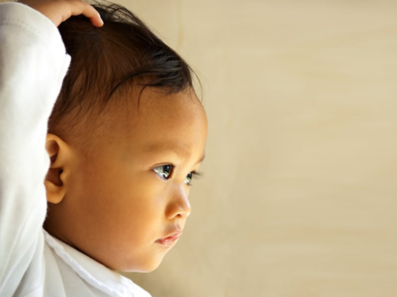 Baby touching head