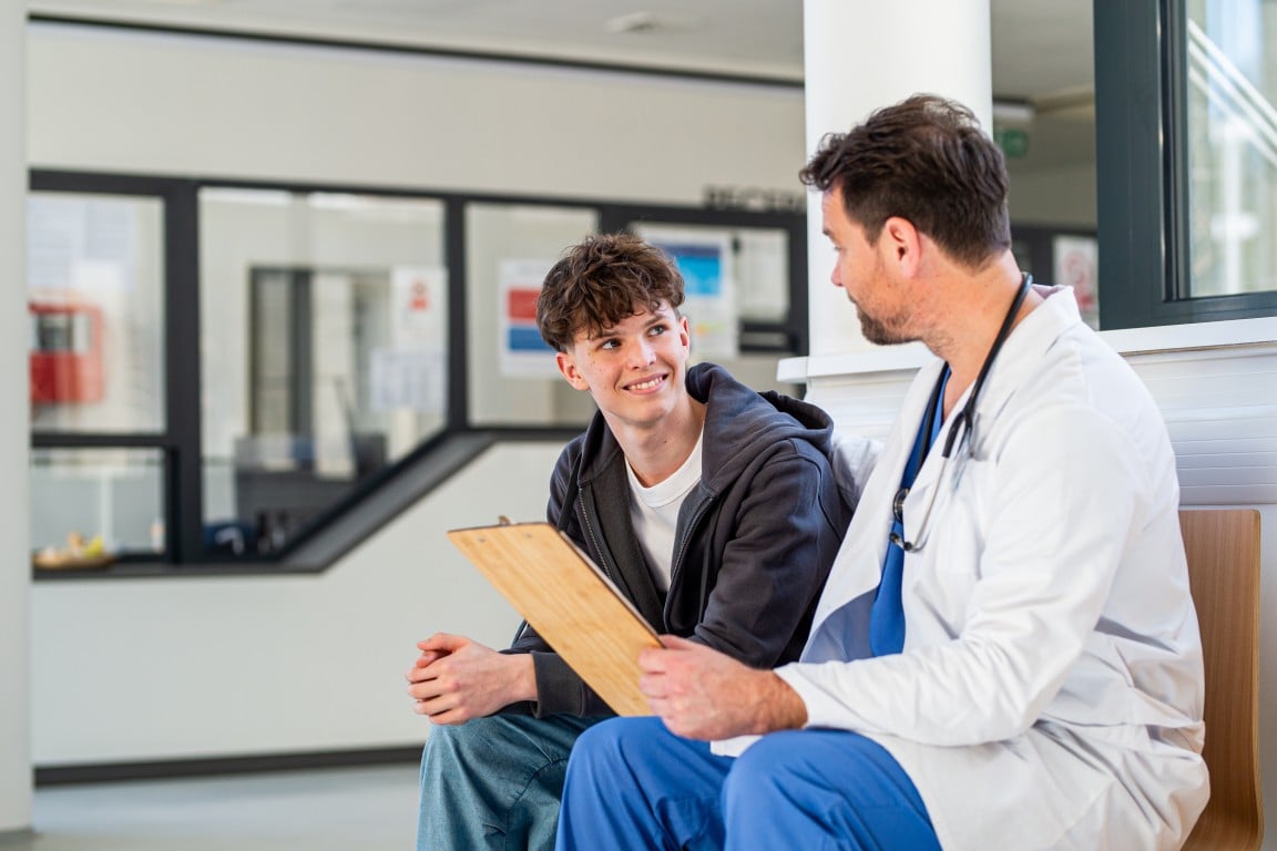 A teenager talking with a doctor