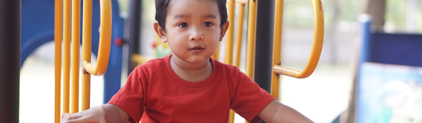 Boy on play equipment