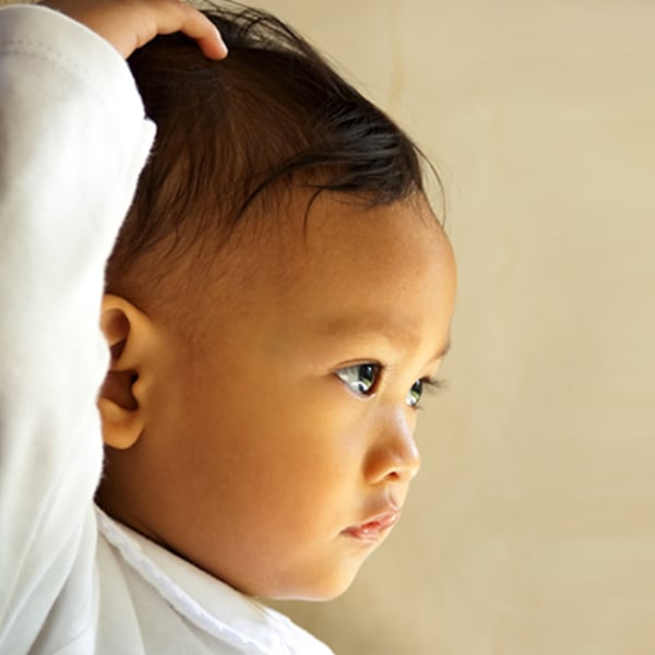Baby touching head