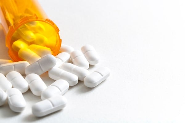 Container of medicine spilling out