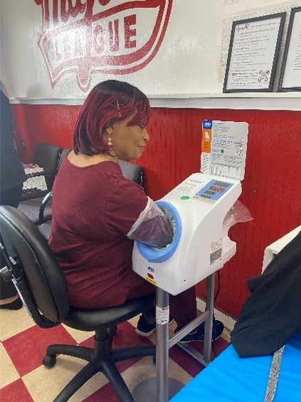 A patient using an automatic blood pressure testing machine