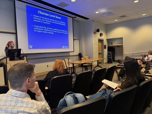 college students in classroom, looking at slideshow