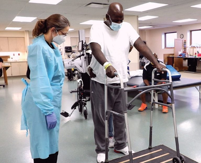 A Rehabilitation patient practicing using a walker on steps