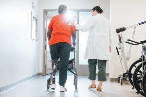 A patient with a prosthetic leg taking steps