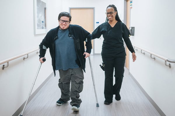 A Rehabilitation patient walking with crutches