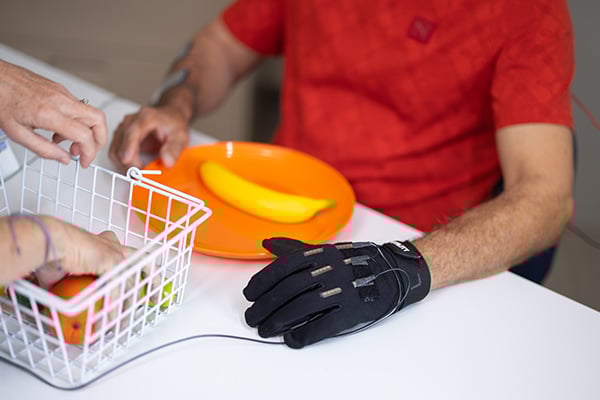 A patient wearing an electrode-wired glove