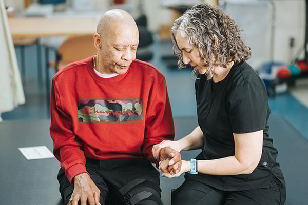 Patient having their hand worked on by provider