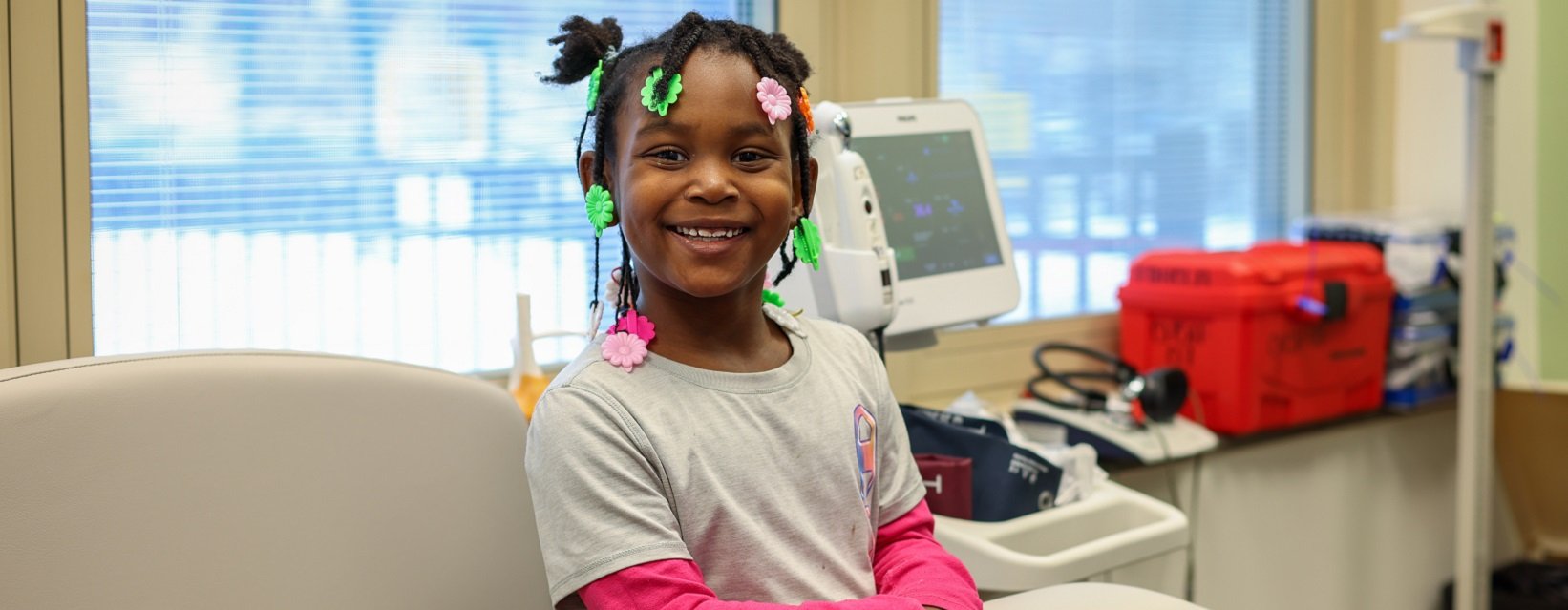school health program student sitting on examination table
