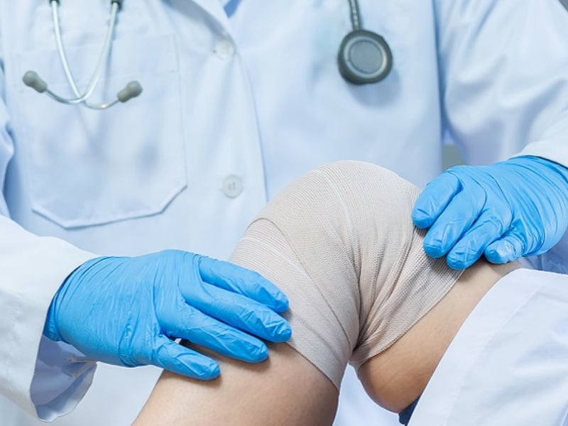 Doctor examining knee