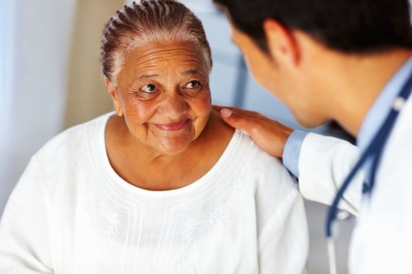 A woman being reassured by her doctor