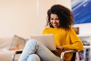 woman on couch with computer