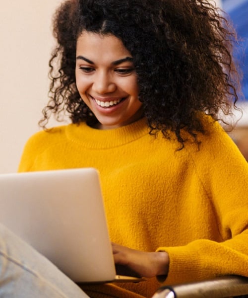 Woman on couch with computer